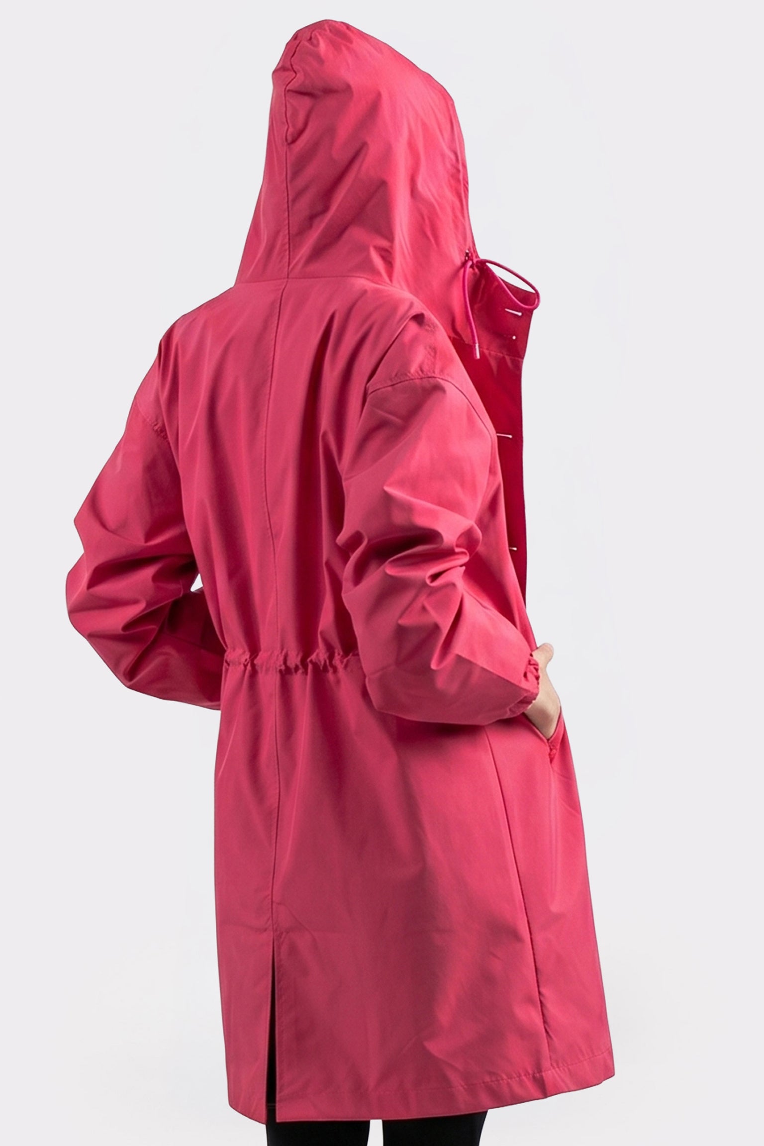 A person wears The Water Resistant Hooded Oversized Windbreaker Rain Jacket in bright pink, featuring an adjustable waist and loose sleeves. Shown from the back against a plain, light background.