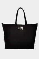 The Urban Slate Waterproof Bag is a spacious black gym and travel bag with two handles and a white "W" embroidered on the front. It's shown against a plain light background.