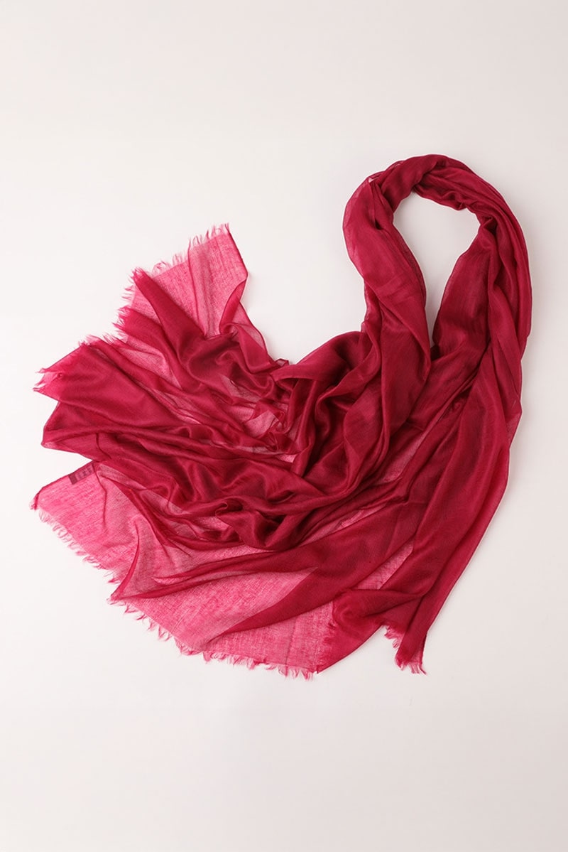 The Velvet Merlot 100% Cashmere Scarf by looselyboho features a sheer, loosely arranged burgundy design with frayed edges, showcased against a light neutral background.